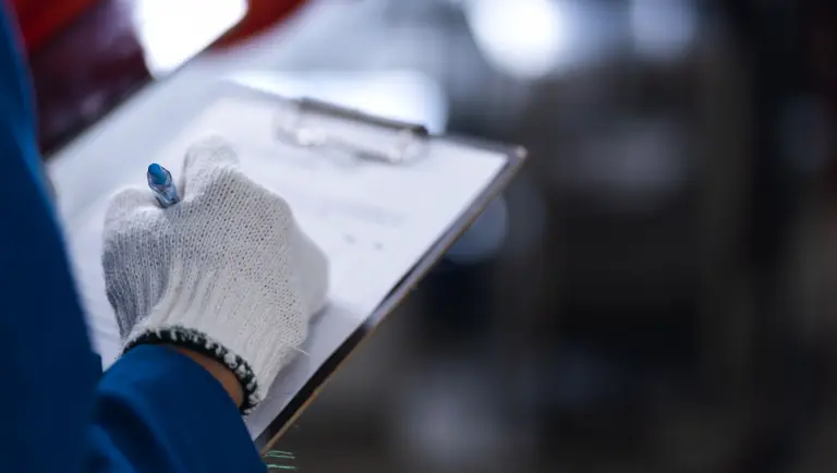 a person in a blue coat performing a technical inspection